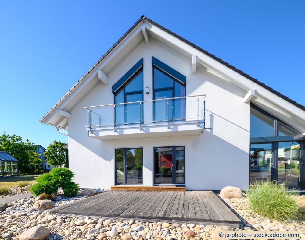 Modernes Einfamilienhaus mit frisch saniertem Balkon, Glasgeländer und Holzterrasse im Aussenbereich