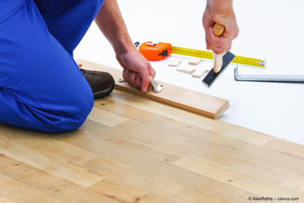 Laminat-wird-mit-Schlagklotz-angehauen