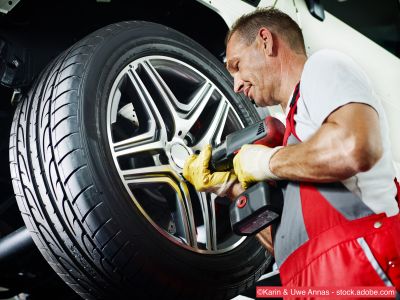 Mechaniker wechselt Autoreifen 