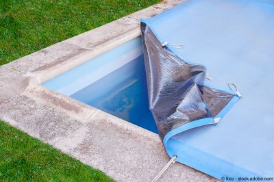 Der Gartenpool wird mit einer Schutzplane abgedeckt, um Wasserverdunstung und Verschmutzung bis zur nächsten Sommersaison zu verhindern