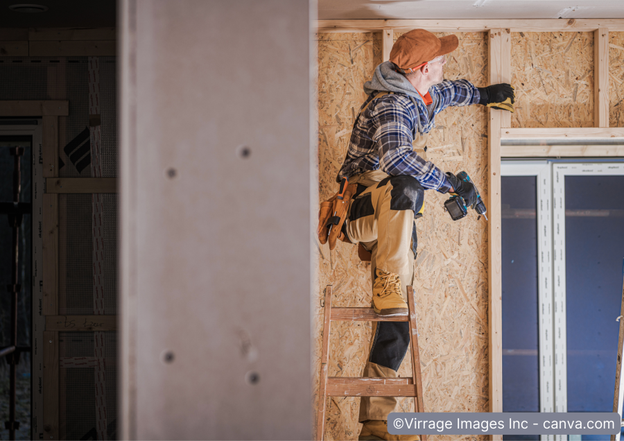 Mann montiert Unterkonstruktion fuer Gipskartonplatten an die Wand